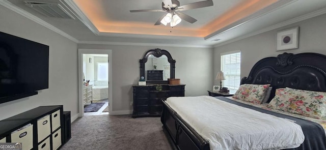 bedroom featuring a raised ceiling, carpet flooring, connected bathroom, crown molding, and ceiling fan