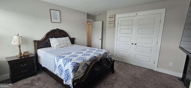 carpeted bedroom with a closet and baseboards