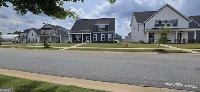 view of front facade featuring board and batten siding and a front lawn