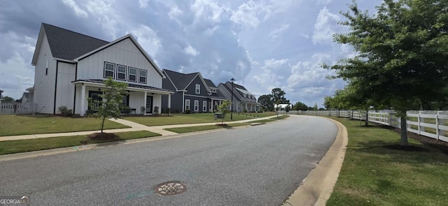 view of asphalt road with curbs and sidewalks