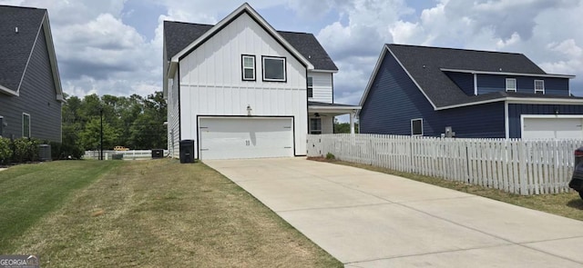 view of front of home with board and batten siding, driveway, a garage, cooling unit, and roof with shingles
