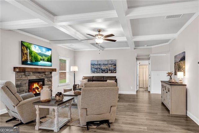 living area featuring wood finished floors, coffered ceiling, ceiling fan, baseboards, and beamed ceiling