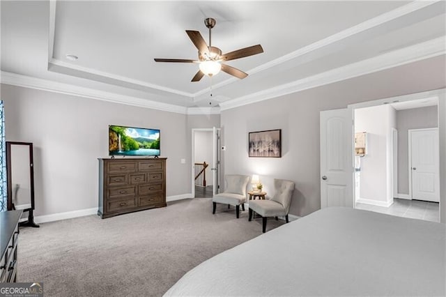 bedroom with a raised ceiling, ornamental molding, carpet floors, baseboards, and a ceiling fan