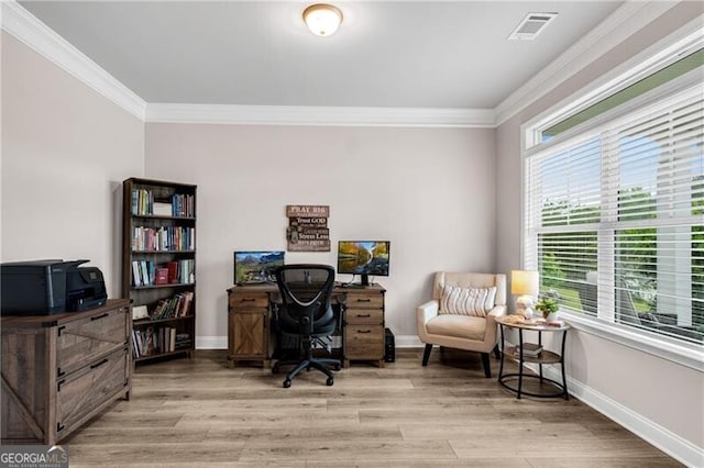 home office with ornamental molding, light wood-type flooring, and baseboards