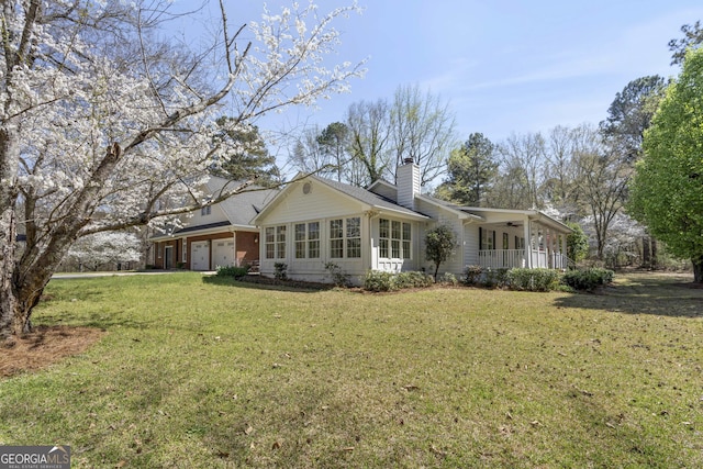 5695 Sweetbriar Trl, Macon, GA 31210 - back of property with an attached garage, a lawn, a chimney, and a ceiling fan