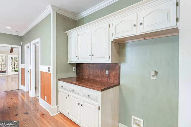5695 Sweetbriar Trl, Macon, GA 31210 - kitchen featuring dark countertops, light wood-style flooring, ornamental molding, white cabinets, and baseboards