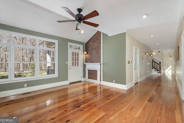 5695 Sweetbriar Trl, Macon, GA 31210 - unfurnished living room with hardwood / wood-style flooring, stairway, a ceiling fan, lofted ceiling, and a large fireplace