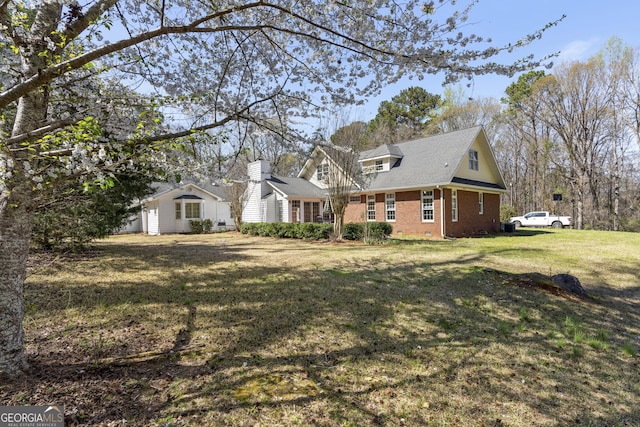 5695 Sweetbriar Trl, Macon, GA 31210 - view of home's exterior with brick siding and a lawn
