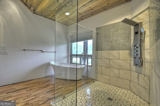 bathroom with a walk in shower, a freestanding tub, wood ceiling, and wood finished floors