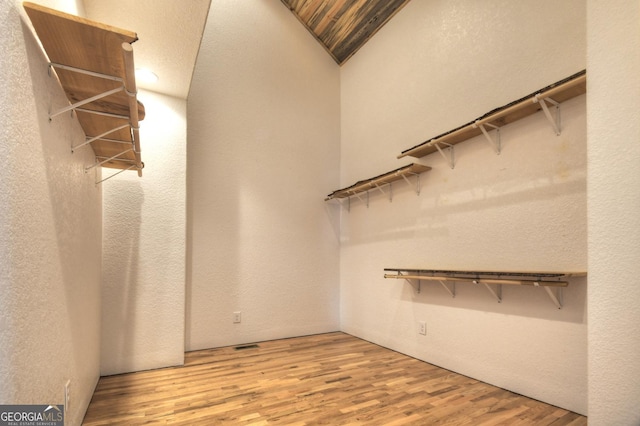 walk in closet with wood finished floors