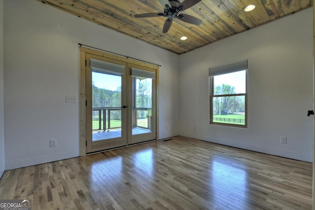empty room featuring wood ceiling, wood finished floors, ceiling fan, french doors, and recessed lighting
