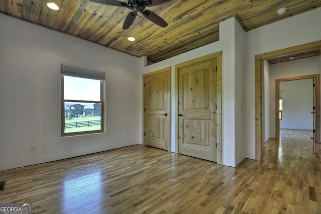 unfurnished bedroom with multiple closets, hardwood / wood-style floors, wood ceiling, and recessed lighting