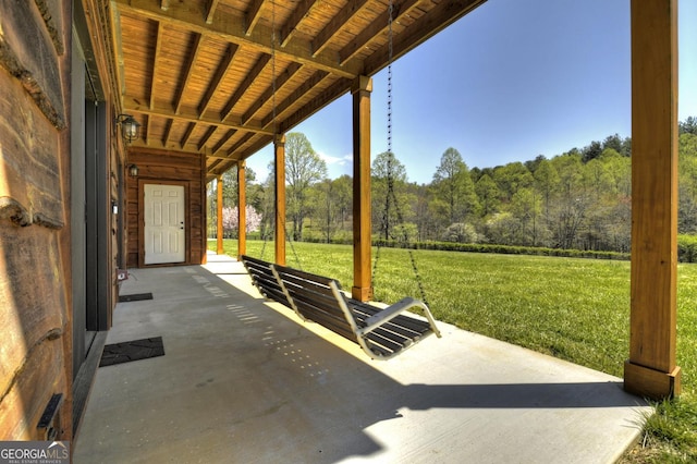view of patio featuring a forest view