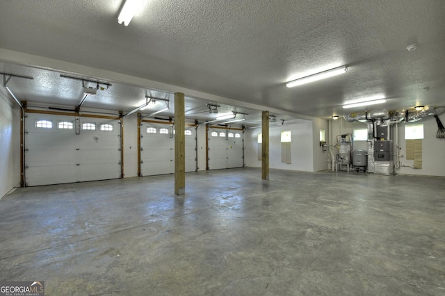 garage featuring heating unit and a garage door opener
