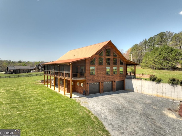 rear view of property with an attached garage and driveway