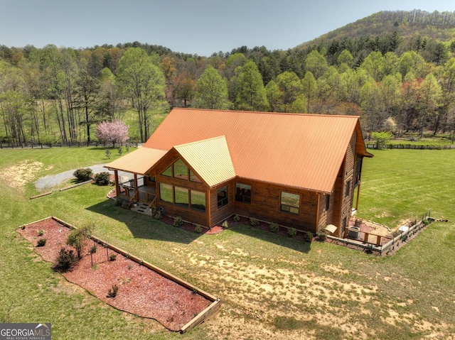 aerial view of property and surrounding area with a forest