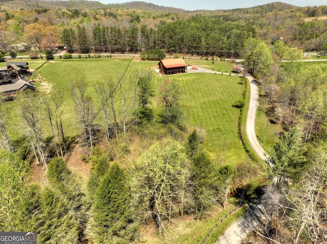 view of rural area featuring a forest