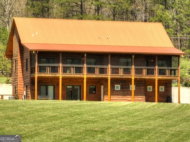 back of house with a yard and metal roof