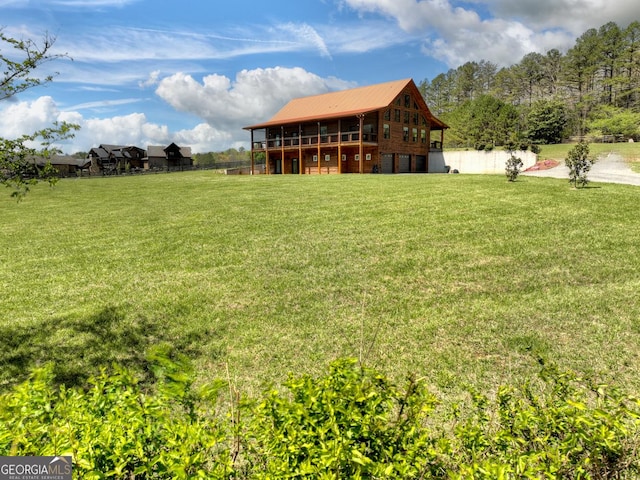 view of green lawn with a deck and a garage