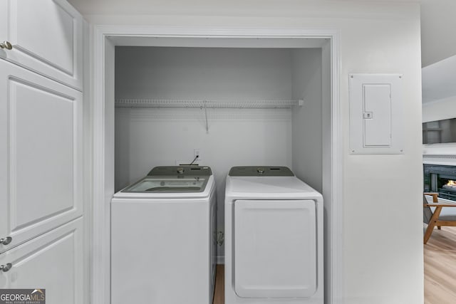 3636 Habersham Rd NW Unit 2101, Atlanta, GA 30305 - laundry room with electric panel, independent washer and dryer, and light wood-style flooring