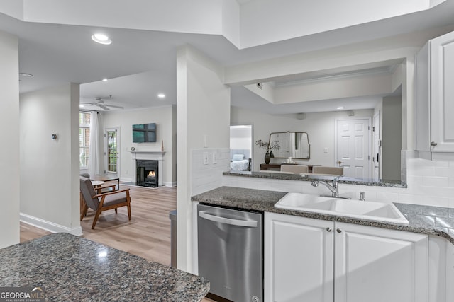 3636 Habersham Rd NW Unit 2101, Atlanta, GA 30305 - kitchen featuring stainless steel dishwasher, a sink, open floor plan, a premium fireplace, and light wood-style floors