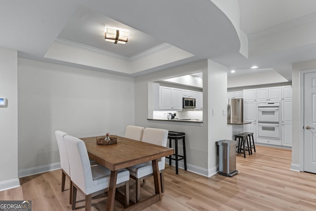 3636 Habersham Rd NW Unit 2101, Atlanta, GA 30305 - dining area featuring a raised ceiling, ornamental molding, baseboards, recessed lighting, and light wood-type flooring