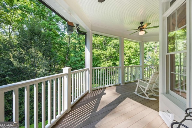 wooden deck featuring ceiling fan