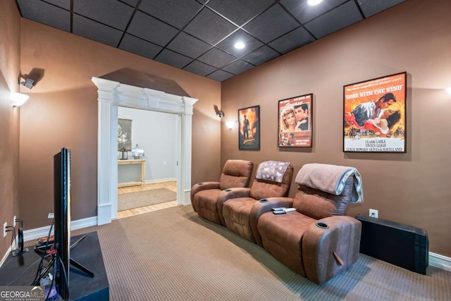 carpeted cinema room with baseboards, recessed lighting, and a paneled ceiling