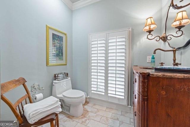 bathroom with crown molding and toilet