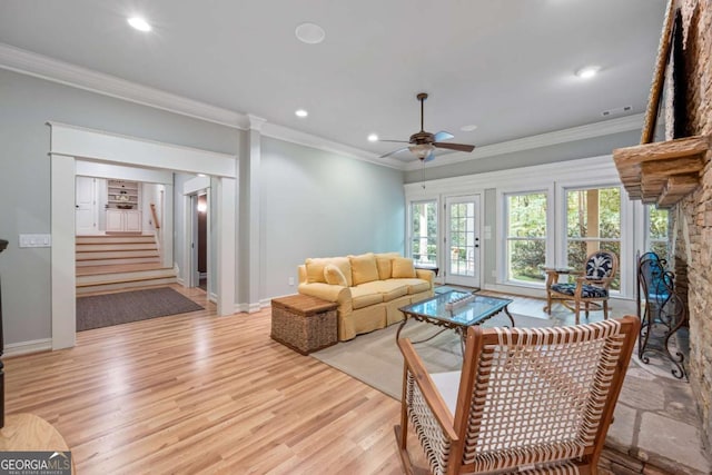 living room with light wood finished floors, ornamental molding, ceiling fan, stairs, and recessed lighting