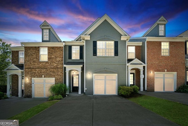 view of property with brick siding and driveway