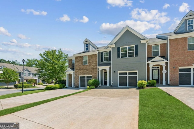 view of property with concrete driveway and brick siding