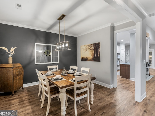 111 Walnut Ln, Williamson, GA 30292 - dining space with wood finished floors, crown molding, baseboards, and a chandelier