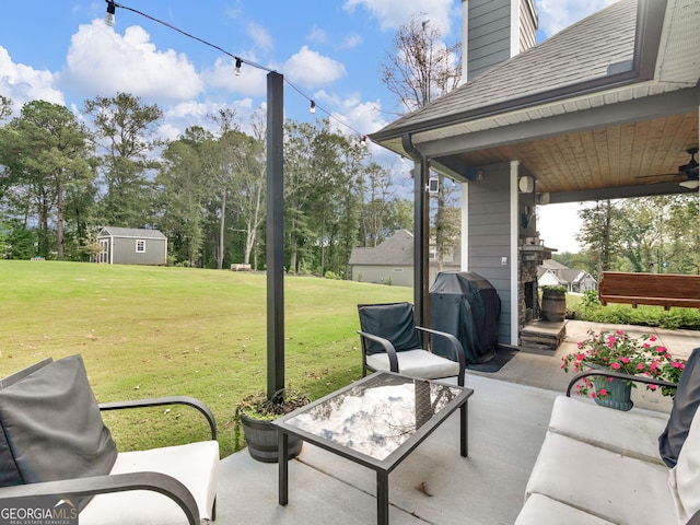 111 Walnut Ln, Williamson, GA 30292 - view of patio with grilling area, a ceiling fan, view of wooded area, and an outbuilding