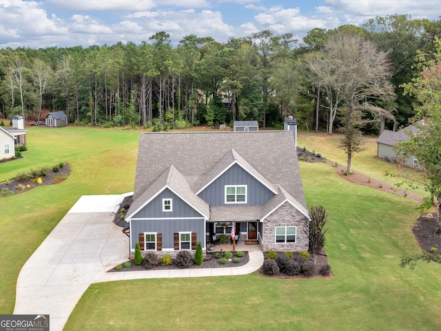 111 Walnut Ln, Williamson, GA 30292 - craftsman house with board and batten siding, stone siding, a porch, a front lawn, and a shingled roof