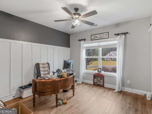 111 Walnut Ln, Williamson, GA 30292 - home office featuring a ceiling fan, light wood-type flooring, and wainscoting