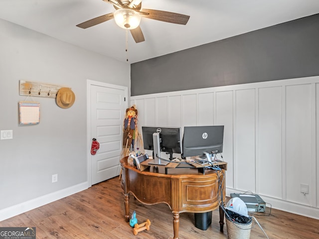 111 Walnut Ln, Williamson, GA 30292 - office space featuring a ceiling fan, wood finished floors, and a decorative wall