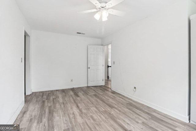 771 James Cir, Lawrenceville, GA 30046 - unfurnished bedroom with light wood-style flooring, baseboards, and ceiling fan