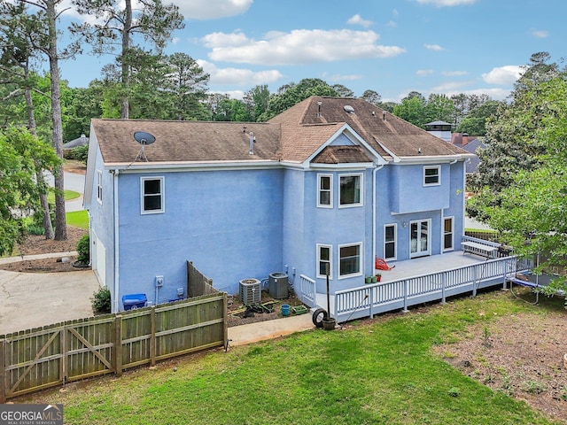 771 James Cir, Lawrenceville, GA 30046 - rear view of house featuring a deck, stucco siding, central AC, and a shingled roof