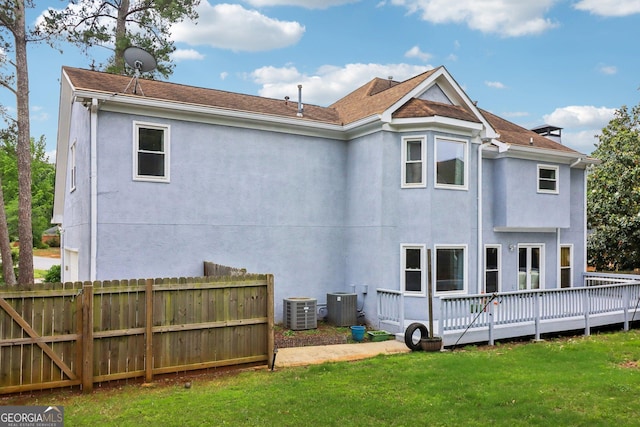 771 James Cir, Lawrenceville, GA 30046 - back of property with a wooden deck, central AC, and stucco siding