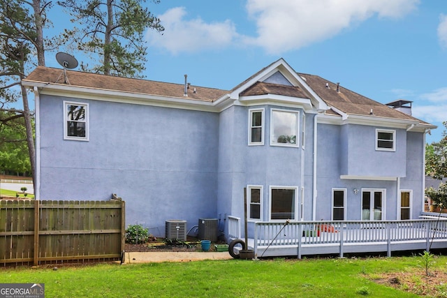 771 James Cir, Lawrenceville, GA 30046 - rear view of property featuring a deck, stucco siding, and central AC