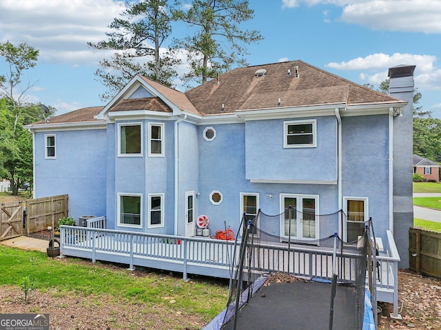 771 James Cir, Lawrenceville, GA 30046 - back of house featuring a deck, a fenced backyard, stucco siding, a chimney, and french doors