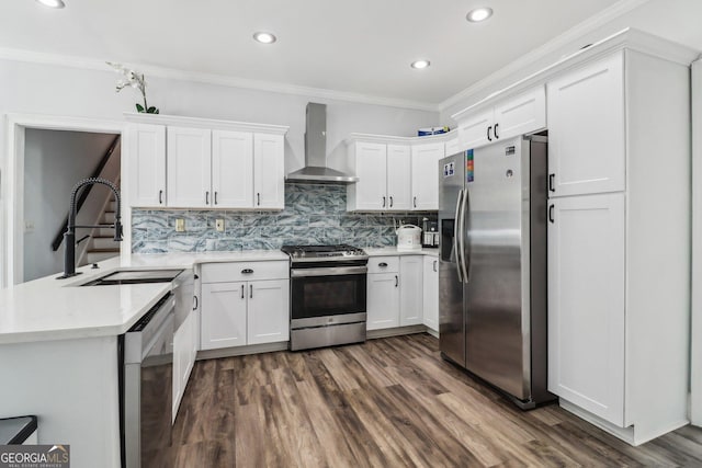 771 James Cir, Lawrenceville, GA 30046 - kitchen featuring stainless steel appliances, wall chimney exhaust hood, a sink, crown molding, and decorative backsplash
