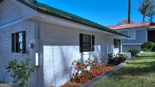 view of side of home with brick siding