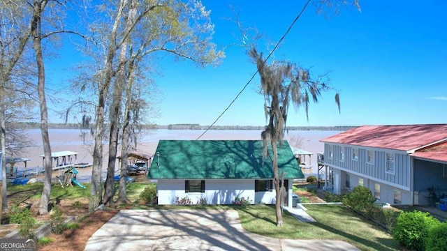 view of front of home with a water view