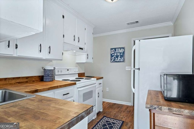 kitchen featuring white appliances, under cabinet range hood, crown molding, white cabinets, and wood counters