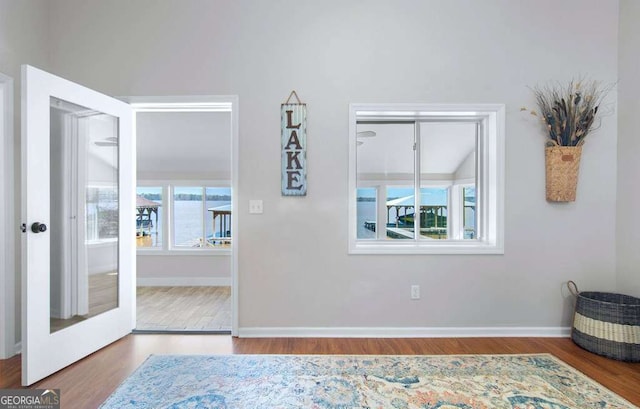 foyer featuring wood finished floors and baseboards