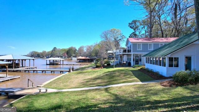 dock area featuring a lawn, a water view, and boat lift