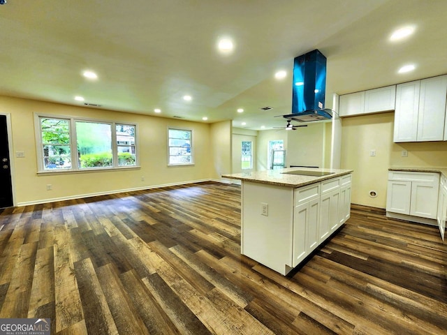 188 Oak Dr, Atlanta, GA 30354 - kitchen featuring open floor plan, extractor fan, dark wood-style floors, white cabinetry, and recessed lighting