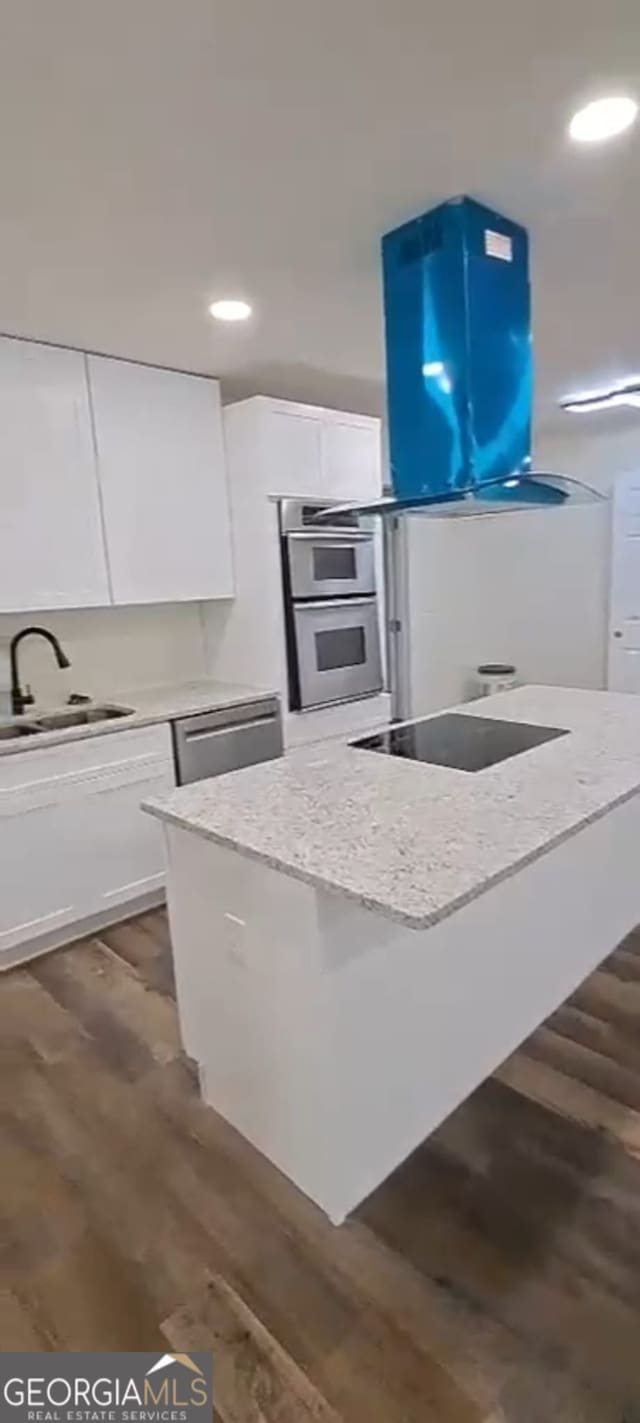 188 Oak Dr, Atlanta, GA 30354 - kitchen featuring black electric cooktop, white cabinetry, dark wood-style flooring, light stone counters, and stainless steel dishwasher